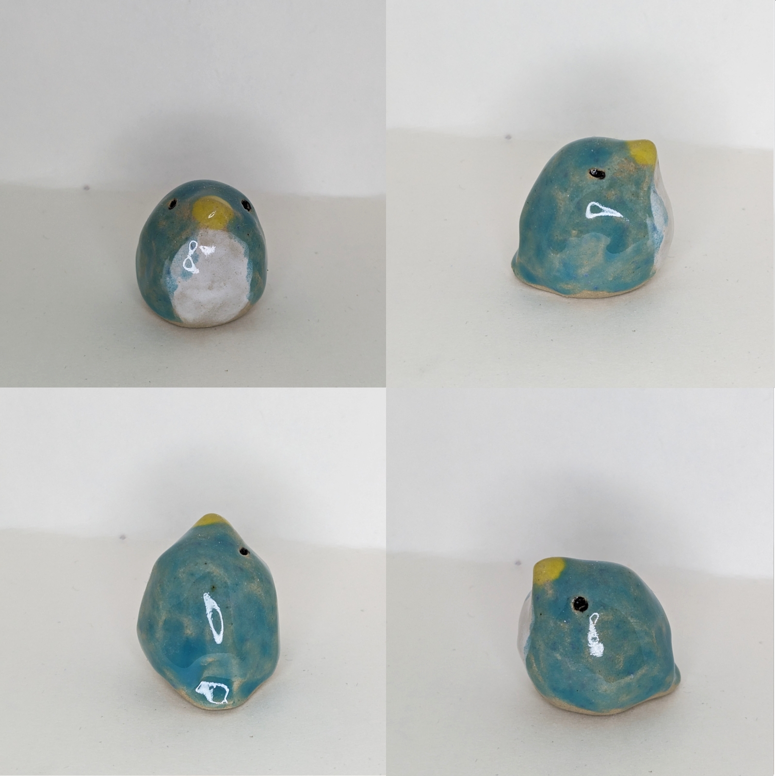 4 views of a small blue and white bird, it is very round. It is ceramic.